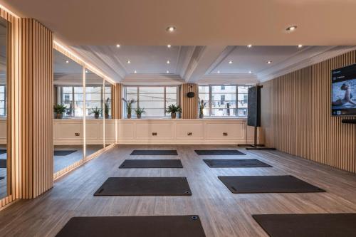 a large room with yoga mats on the floor at The Level at Melia White House in London