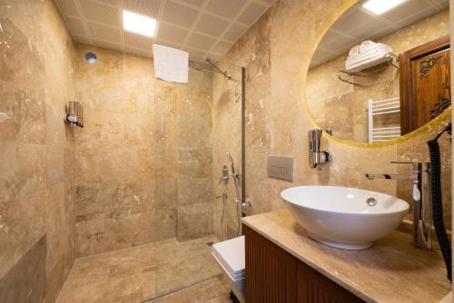 a bathroom with a sink and a mirror at Latona Stone Palace in Nevsehir