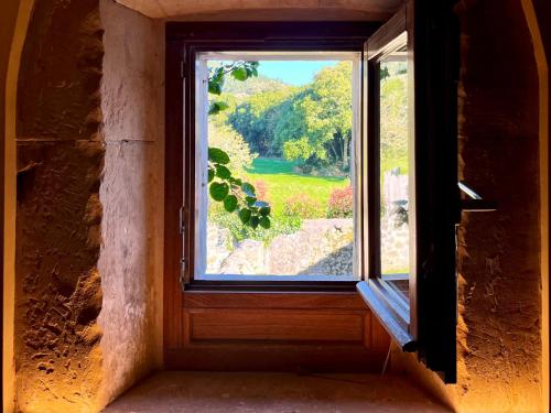 an open window with a view of a garden at Casona Molinos del Agua in Arnuero