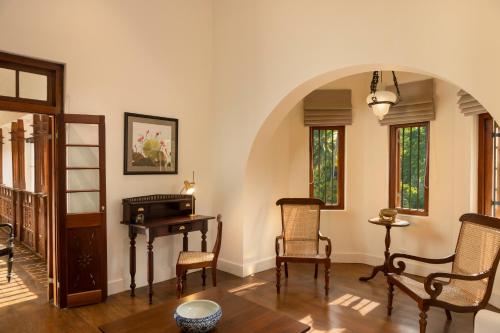 a living room with a table and chairs at Jetwing Wahawa Walauwa, A Luxury Reserve in Rambukkana