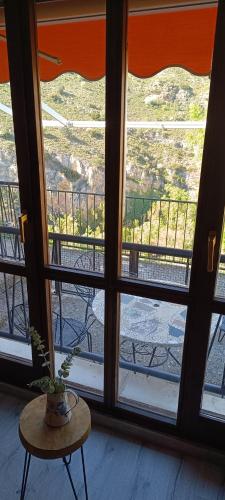 a room with a window with a table and a view at Casa Rural Reyes in Nuévalos