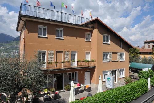 a hotel with flags on top of it at Hotel Bellavista Meublè in Monte Isola