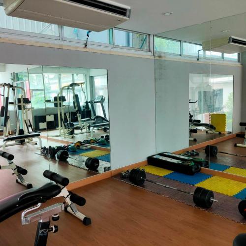 a gym with a lot of exercise equipment on the floor at Boss Mansion in Bangkok