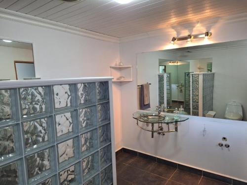 a bathroom with a sink and a mirror at Nature's View - Dana Bay in Mossel Bay