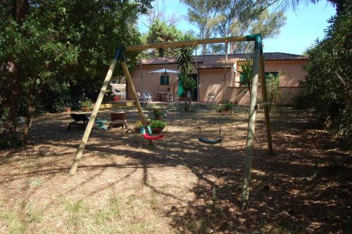 a swing set in the yard of a house at Villa Eucalipti immersa nel verde e sul mare in Magazzini