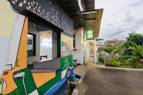 a building with a skateboard painted on the side of it at RedDoorz Syariah near Taman Air Mancur Bogor in Bogor