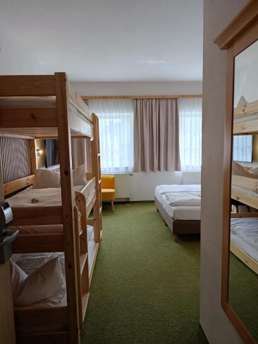 a hotel room with two bunk beds and a room with at Familienhotel nahe der Therme Erding in Erding