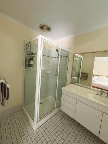 a bathroom with a shower and a sink at Spacious home in Shailer Park in Tanah Merah