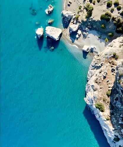 an aerial view of a rocky shore with blue water at Filocsenia luxury apartment at tsoutsouras in Tsoútsouros