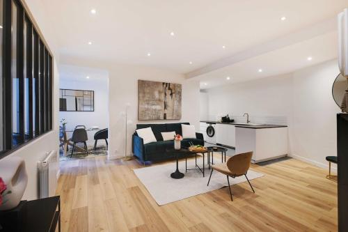 un salon et une cuisine avec un canapé et une table dans l'établissement Beautiful 3BR 8P Nation Apartment, à Paris