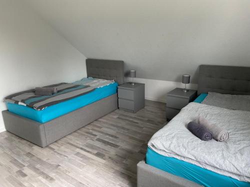 a bedroom with two beds and two night stands at Eastside-Apartment WHG 01 in Senftenberg