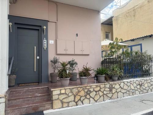 a front door of a house with potted plants at Luxury house near by Delphi in Kírra