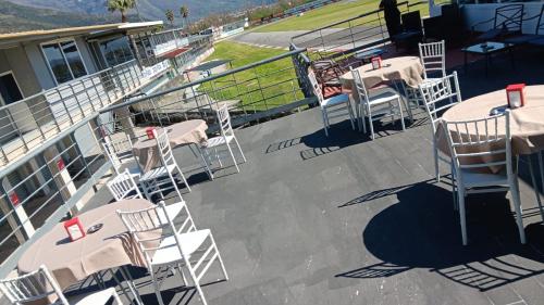 a deck with tables and chairs on a boat at Hotel Saturday in Palma Campania