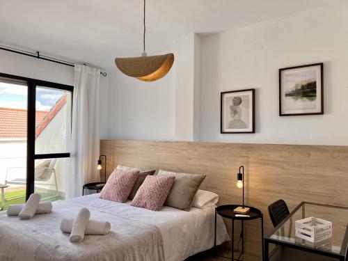 a bedroom with a bed and a large window at ChicFlat Río Ciudad Real Dúplex en el centro in Ciudad Real