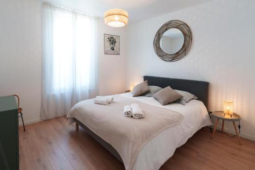 une chambre avec un lit avec deux serviettes dessus dans l'établissement Le refuge Champenois, à Verneuil