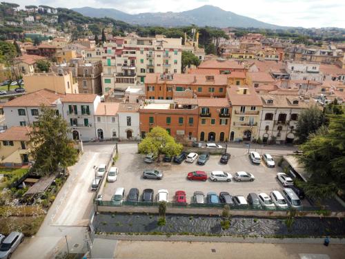 an aerial view of a city with cars parked in a parking lot at poppy loft in Grottaferrata