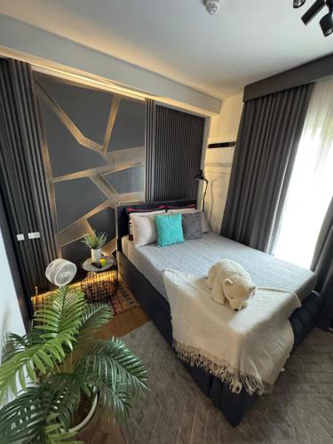 a bedroom with a bed with a stuffed dog sitting on a platform at Studio McBi in Davao City