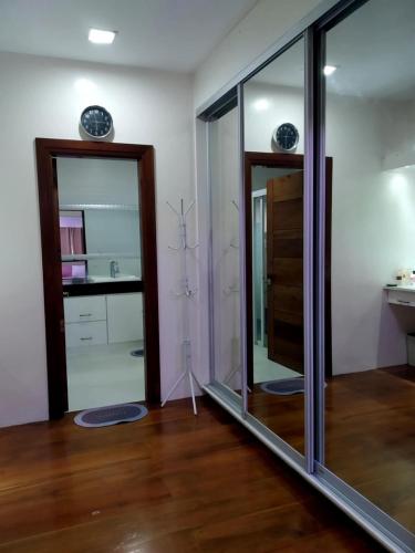 a room with two glass doors and a wooden floor at Queen Isabel Private Villa and Events Place in Tagaytay