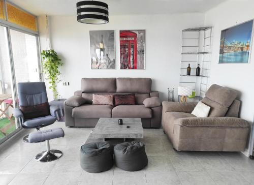a living room with a couch and a table at Terrace & Sea Views in Cullera in Faro de Cullera