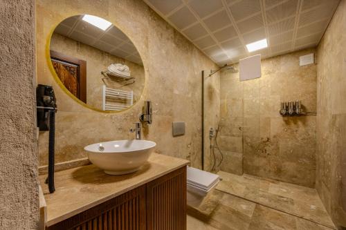 a bathroom with a sink and a shower at Latona Stone Palace in Nevsehir
