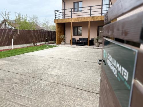 a house with a driveway in front of it at Casa lui Matei Murighiol in Murighiol