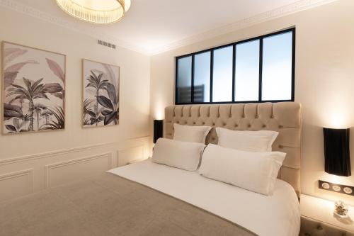 a bedroom with a large bed with white pillows at Pick A Flat's Apartments in Batignolles - Rue Gauthey in Paris