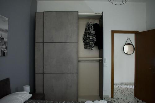 a tall refrigerator in a room with a bed at Fly Home - 15 minutes to ROME in Ciampino