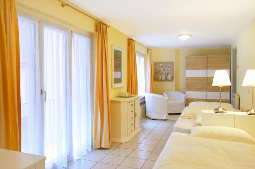 a hotel room with two beds and a window at Depandance Garni Golf in Ascona