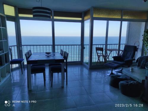 a dining room with a table and chairs on a balcony at Terrace & Sea Views in Cullera in Faro de Cullera