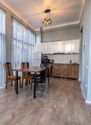 a kitchen with a dining room table and chairs at Коттедж Иссык - Куль in Chon-Sary-Oy