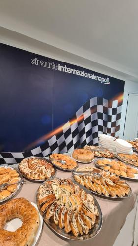 a table full of pies and pastries on at Hotel Saturday in Palma Campania