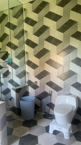 a bathroom with a toilet and a shower at Rumah Malika in Munggu