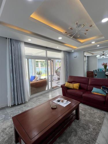 a living room with a red couch and a table at La villa des anges in Kribi