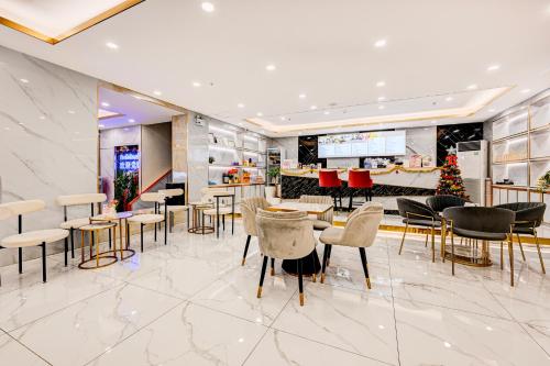 a lobby with tables and chairs and a christmas tree at Dancenter Bangkok Travellers Hotel in Bangkok