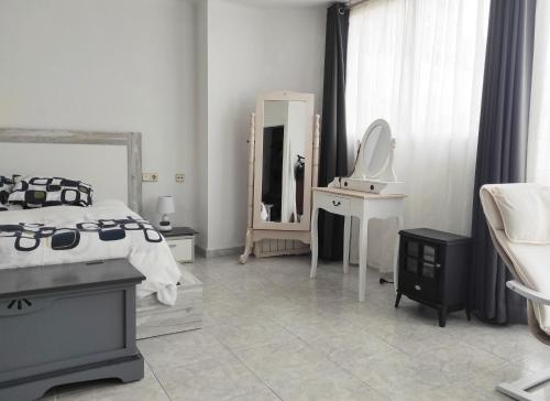 a white bedroom with a bed and a mirror at Terrace & Sea Views in Cullera in Faro de Cullera