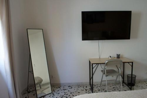 a mirror and a table and a table and chair at Fly Home - 15 minutes to ROME in Ciampino
