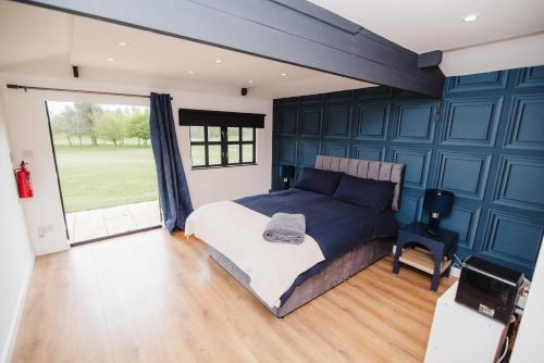 a bedroom with a bed and a large window at The Nook at Bar918 in Sandbach