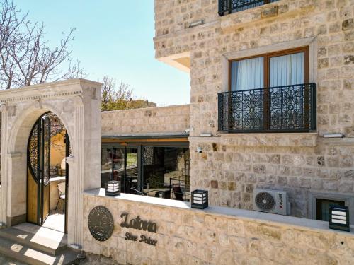 a stone building with a door and a window at Latona Stone Palace in Nevsehir