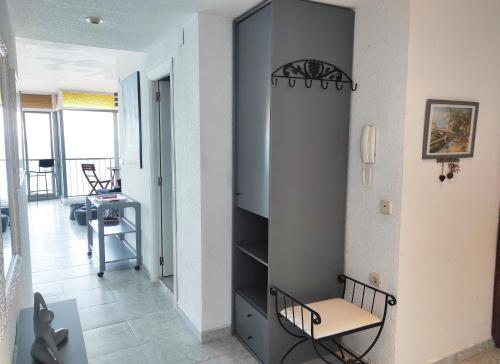 a room with a closet with a table and a chair at Terrace & Sea Views in Cullera in Faro de Cullera
