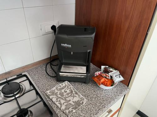 a printer sitting on a counter next to a stove at appartamento genziane in Genova