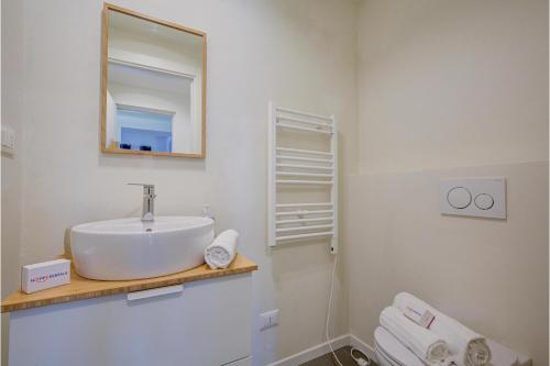 a white bathroom with a sink and a mirror at Suono del Lago 100m from Lake - Happy Rentals in Meina