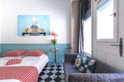une chambre avec un lit, un canapé et une fenêtre dans l'établissement Artisan Lofts Paris close Eiffel Tower, à Paris