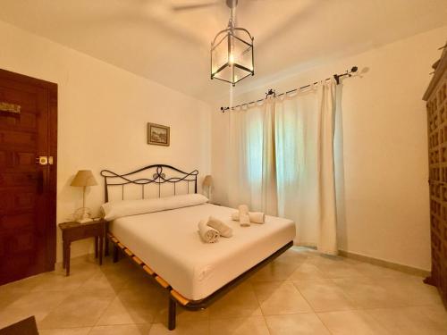 a bedroom with a bed with two towels on it at AT060 Villa Ortenbach in Ifach