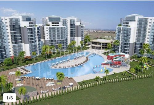 an aerial view of a resort swimming pool with tall buildings at Sunny escape Holiday apartment in İskele