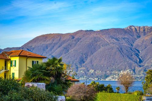 a house with a view of the water and mountains at Residenz Lagobello in Germignaga