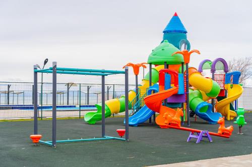 a childrens playground with a colorful play equipment at Коттедж Иссык - Куль in Chon-Sary-Oy