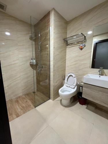 a bathroom with a shower and a toilet and a sink at Cozy Apartment in Batam in Jodoh