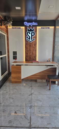 a ping pong table in a room with a sign at Hotel Sangam Palace in Chittaurgarh