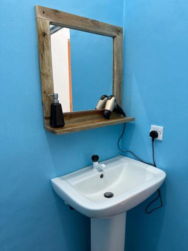 a bathroom with a mirror and a white sink at Sea La Vie in Arugam Bay