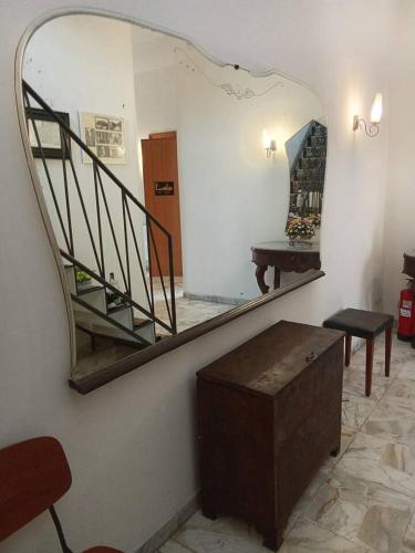 a mirror in a room with a staircase and a table at B&B Piazza dei Leoni in Sezze